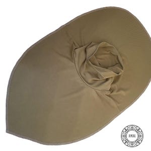 May include: A tan sun hat with a wide brim and a neck covering. The hat has a rounded crown and a wide brim, with a stitched edge. The neck covering is a tube of fabric. The hat is made of a soft, lightweight material.