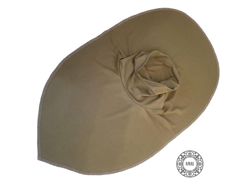 May include: A tan sun hat with a wide brim and a neck covering. The hat has a rounded crown and a wide brim, with a stitched edge. The neck covering is a tube of fabric. The hat is made of a soft, lightweight material.