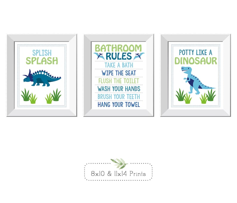 May include: Three framed prints with dinosaur themes. One says "Splish Splash" with a blue dinosaur. Another lists "Bathroom Rules." The third says "Potty Like a Dinosaur." The prints are available in 8x10 and 11x14 sizes.