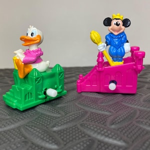Mickey Mouse and Donald Duck on parade floats wind-up figures