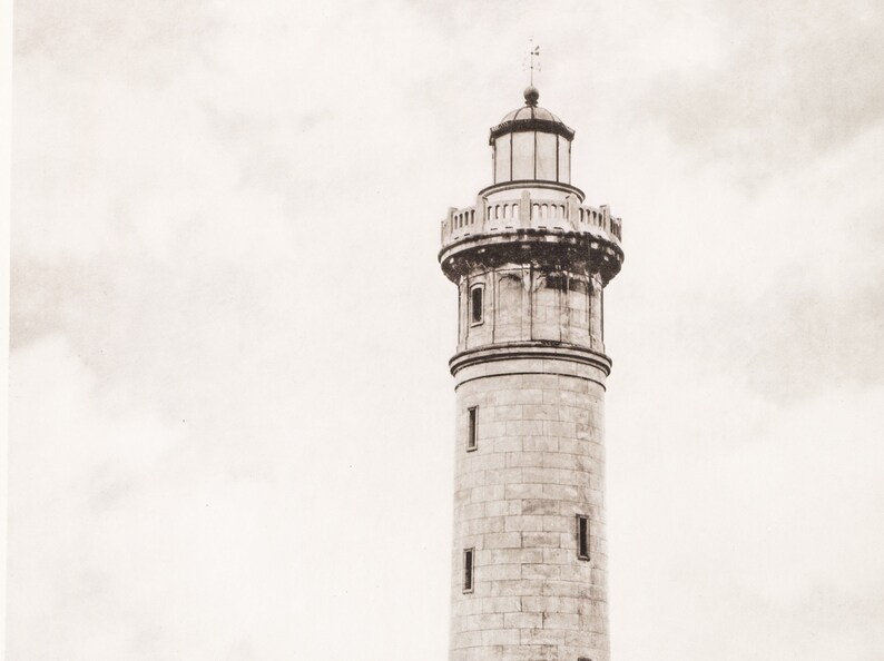 May include: A tall, stone lighthouse with a white, cloudy sky in the background.