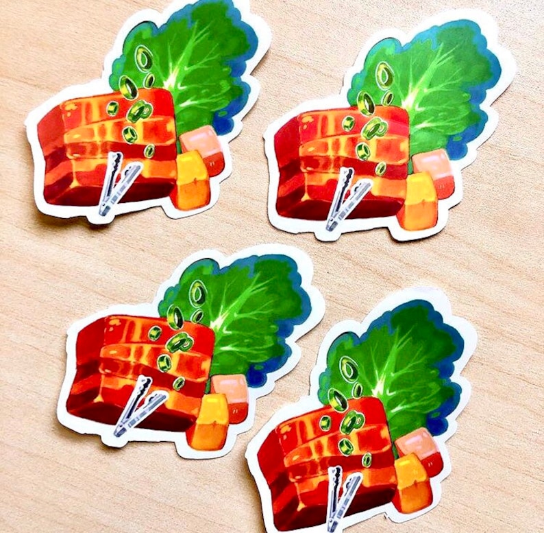 May include: Four stickers featuring a colorful illustration of a dish with red, orange, and green elements. Each sticker depicts a rectangular block of food, green leafy vegetables, and small orange cubes. Small silver tongs are also included in the design.