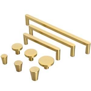 May include: A set of gold cabinet hardware, including three different sizes of bar pulls and four different sizes of round knobs.
