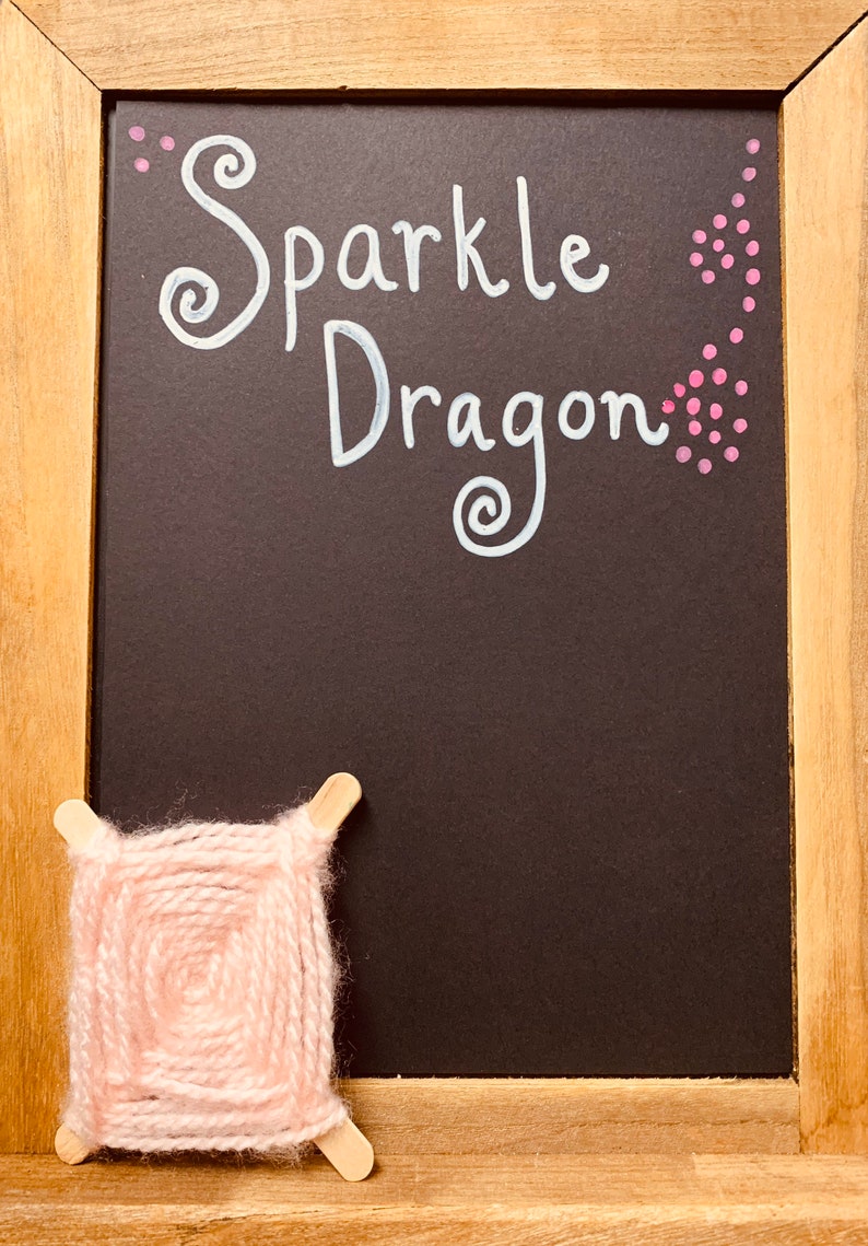 Soft pink spider web knitted artwork.