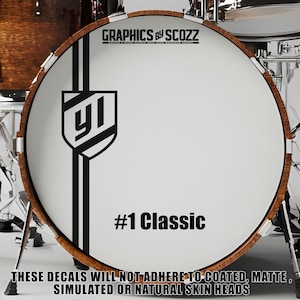 May include: A black and white drumhead decal with a stylized "YI" logo and the text "#1 Classic". The decal is designed for use on drumheads.