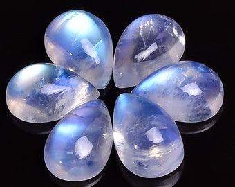 May include: Six teardrop-shaped moonstone cabochons in various shades of blue and white, arranged in a circular pattern on a black background.