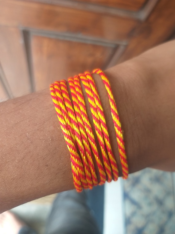 Colorful braided friendship bracelets handmade of thread and knots isolated  on black background Stock Photo - Alamy