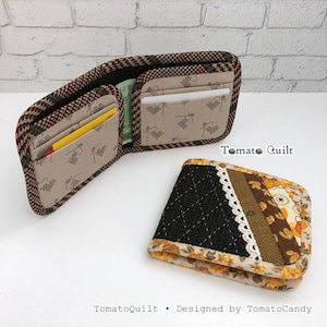May include: A bifold wallet with a brown and black houndstooth exterior and a beige interior featuring a cross-stitch pattern. A second wallet is closed, displaying a black quilted section, lace trim, and floral fabric. Text reads Tomato Quilt.
