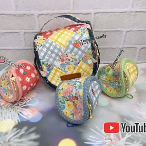 May include: Three colorful fabric pouches with zippers and floral patterns. The pouches are made of patchwork fabric and have a quilted texture. The pouches are arranged on a white surface with a brick wall in the background. The pouches have the text "Tomato candy" on them.