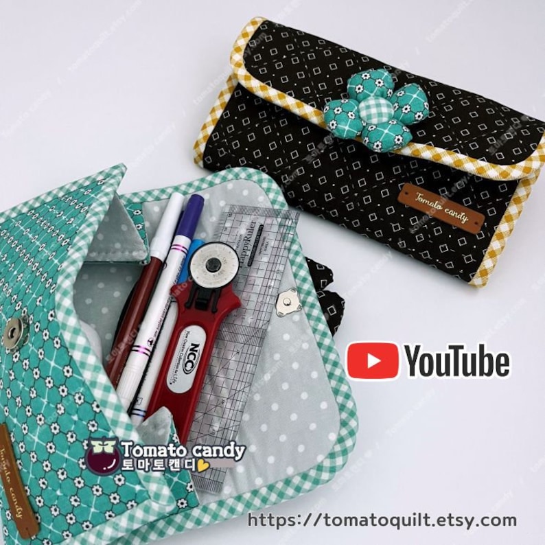May include: Two fabric pouches with a checkered pattern and a flower embellishment. The pouch on the left is open and contains a ruler, a rotary cutter, and pens. The pouch on the right is closed and has a label that says "Tomato candy". The image also includes a YouTube logo and a website address.