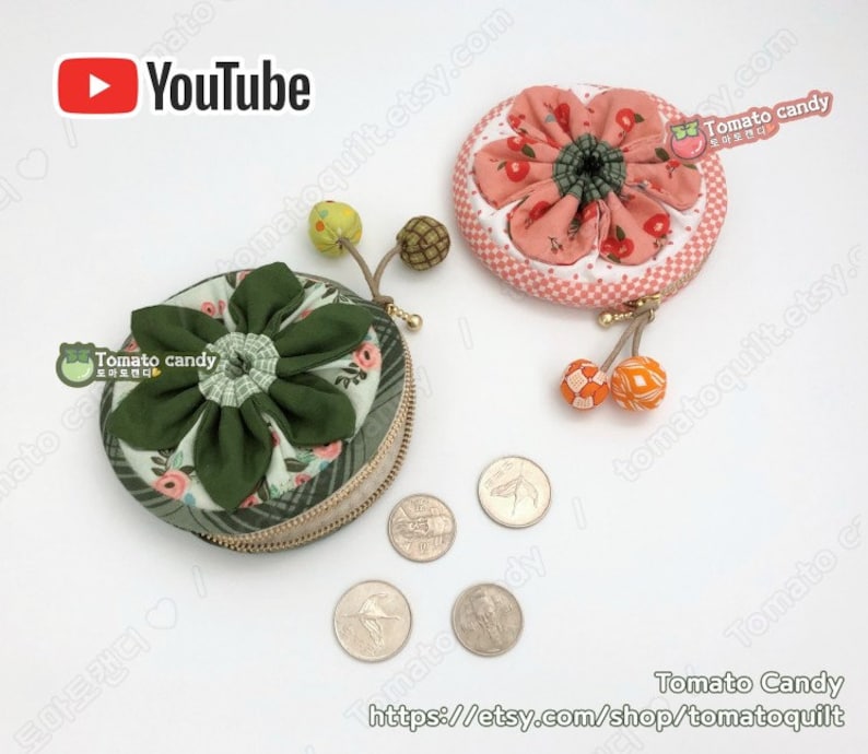 K&ouml;nnte beinhalten: Zwei runde M&uuml;nzbeutel mit floralen Stoffdesigns. Eine B&ouml;rse ist gr&uuml;n mit einem wei&szlig;en Blumenmuster und die andere ist rosa mit einem wei&szlig;en und roten Kirschmuster. Beide Beutel haben einen Rei&szlig;verschluss und einen kleinen Quasten.