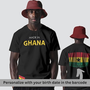 May include: Black t-shirts with "MADE IN GHANA" in yellow text. The front of the shirt has the text and a small Ghana flag. The back of the shirt has a barcode design with the Ghana flag colours and a birth date. The text says "Personalise with your birth date in the barcode."