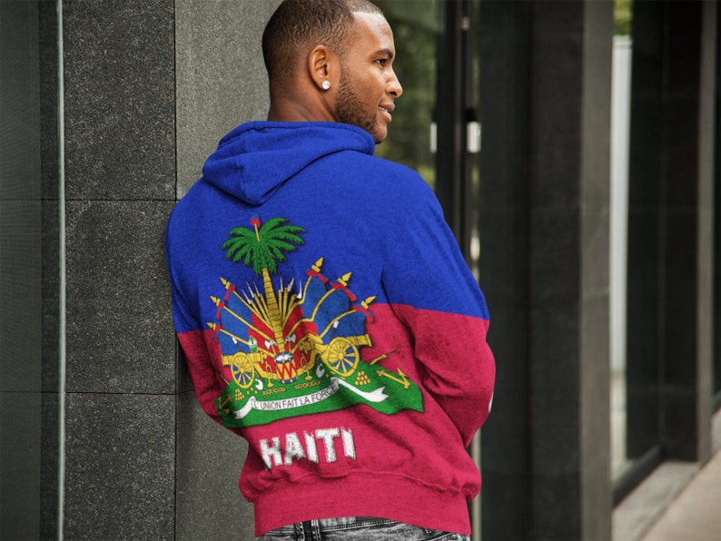 May include: A blue and red hoodie with the Haitian flag and the word "HAITI" printed on the back.