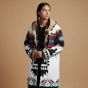 May include: A long white coat with a geometric pattern in black, burgundy, teal, and tan. The coat has a hood with a tan faux fur lining. The coat is worn over a black shirt.