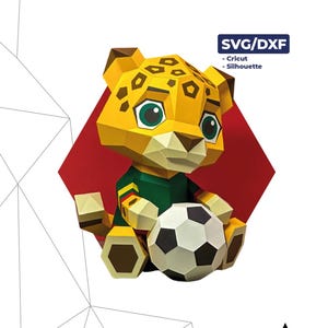 Könnte beinhalten: Ein 3D-Papierbastelmodell eines gelben Leoparden namens Baby Zayu, der ein grünes Trikot trägt und einen schwarz-weißen Fußball hält. Das Design besteht aus 58 Teilen, misst 25 cm x 19 cm x 19 cm und ist mit SVG/DXF-Dateien für Cricut- und Silhouette-Maschinen kompatibel.
