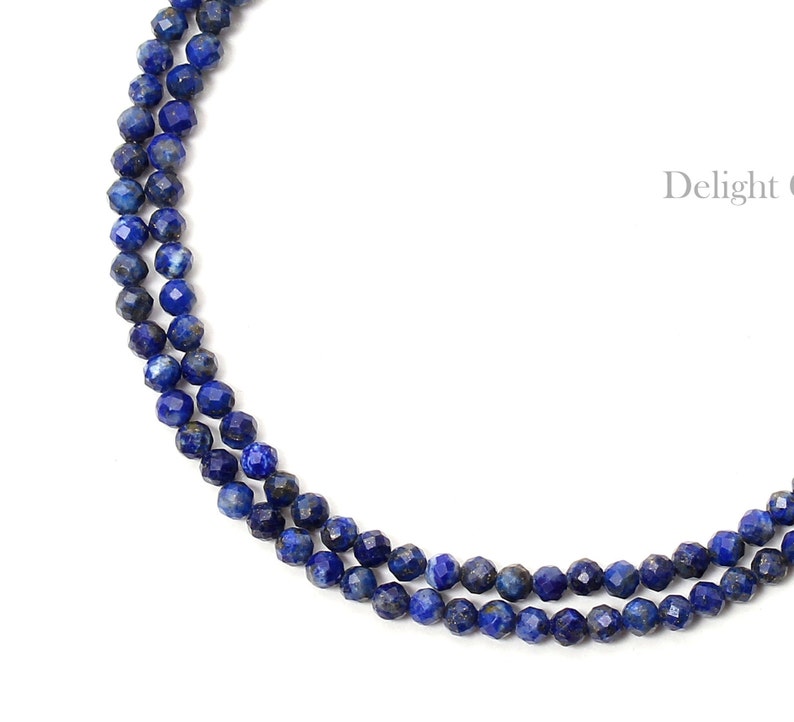 May include: A double strand necklace made of dark blue faceted lapis lazuli beads.
