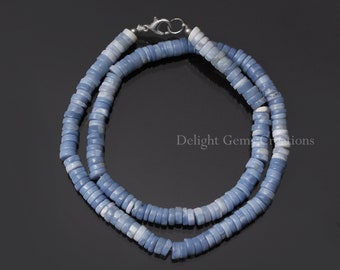 May include: A light blue opal bead necklace with a silver clasp. The necklace is made of many small, round beads that are strung together.
