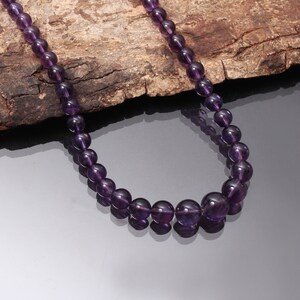 May include: A purple amethyst gemstone necklace with round beads.