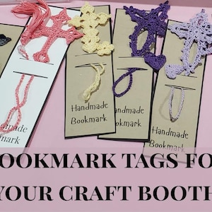 Pode incluir: Uma coleção de marcadores de livros feitos à mão em várias cores e designs, incluindo cruzes, estrelas e corações. Cada marcador está anexado a uma etiqueta que diz "Handmade Bookmark". A imagem também inclui o texto "BOOKMARK TAGS FOR YOUR CRAFT BOOTH".