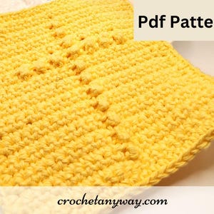 May include: A yellow crocheted dishcloth with a textured pattern. The text "Pdf Pattern" is in the upper right corner of the image. The text "crochetanyway.com" is in the lower right corner of the image.
