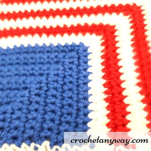 May include: Close-up of a crocheted square with red, white, and blue yarn. The square is made with a simple stitch and has a textured look. The text "crochetanyway.com" is visible in the bottom right corner.