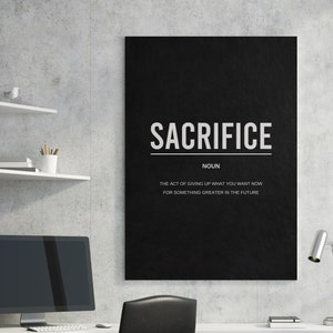 May include: Black and white motivational poster with the word "SACRIFICE" in bold white letters. The text below defines sacrifice as "the act of giving up what you want now for something greater in the future."