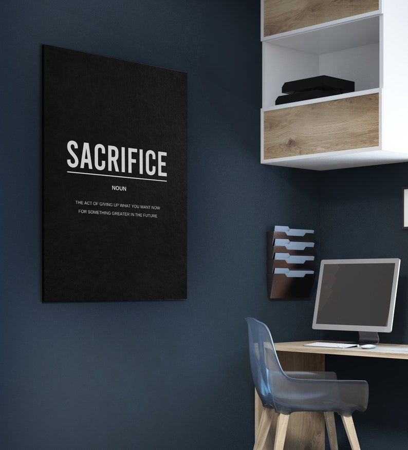 May include: A black and white motivational poster with the word "SACRIFICE" in large white letters. The definition of the word is written below in smaller white letters: "The act of giving up what you want now for something greater in the future."