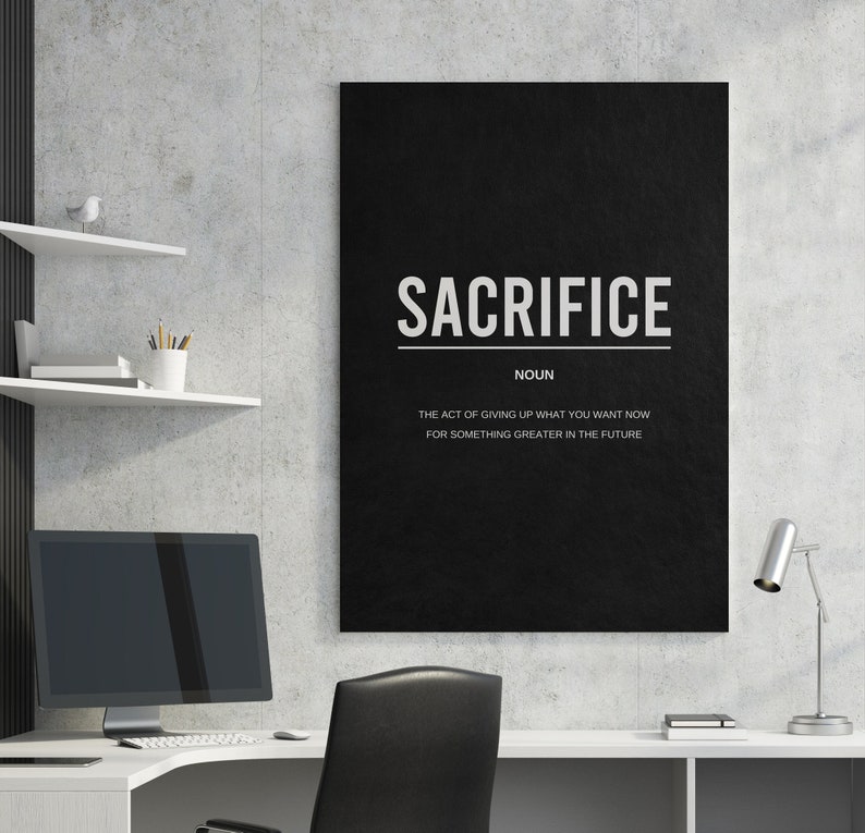 May include: Black and white motivational poster with the word "SACRIFICE" in bold white letters. The text below defines sacrifice as "the act of giving up what you want now for something greater in the future."