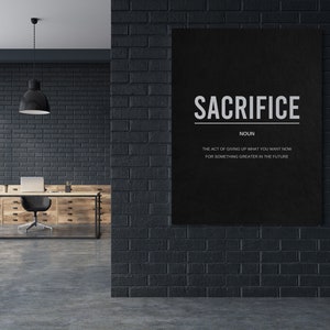 May include: Black and white motivational poster with the word "SACRIFICE" in bold white letters. The text below defines sacrifice as "the act of giving up what you want now for something greater in the future."