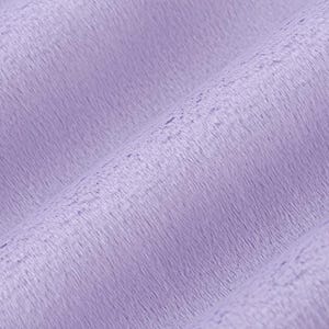 May include: A close-up of a soft, plush fabric in a light lavender colour. The fabric has a subtle texture and a slightly fuzzy appearance.