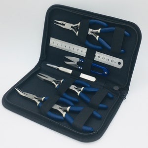 May include: A black zippered case containing a set of seven jewellery making tools, including pliers, tweezers, and a ruler. The tools have blue handles and are arranged in the case.