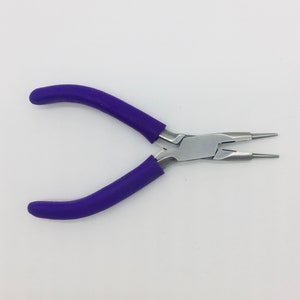 May include: Pliers with purple handles and a silver metal head with two pointed tips. The pliers are used for jewellery making.