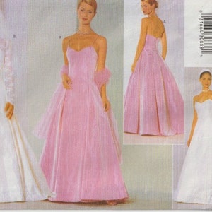 May include: A Butterick sewing pattern featuring multiple bridal gown designs. The image showcases a white wedding dress with a lace bolero, and a pink strapless gown with a matching wrap. The pattern also includes a strapless white dress.