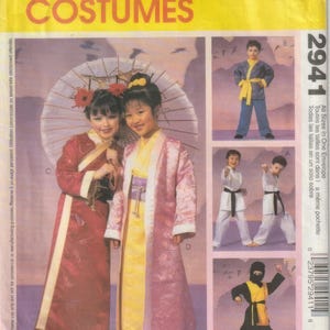May include: McCall's Costumes pattern envelope showing children's costume designs. The designs include a red and gold robe, a pink and yellow robe, a blue and yellow outfit, and karate and ninja costumes.