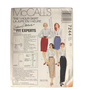 Könnte beinhalten: McCall's Schnittmuster für einen 1-Stunden-Rock, Größe 20. Die Verpackung zeigt Illustrationen von Frauen, die verschiedene Rockstile tragen. Der Text enthält "The Fit Experts" und Anweisungen in Englisch und Französisch. Das Muster bietet leicht verständliche Anweisungen.