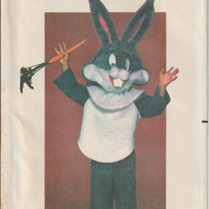 May include: Vintage Butterick sewing pattern for a Bugs Bunny costume. The pattern includes a Bugs Bunny head, white bib, dark green pants, and a carrot. The Looney Tunes licensed product is for sizes S-M-L.