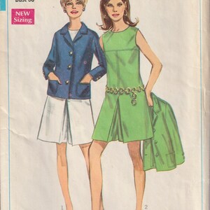 Può includere: Modello di cucito Simplicity vintage 7528. L'illustrazione mostra due donne che indossano abiti e giacche. Una donna indossa una giacca blu e una gonna bianca, l'altra un vestito verde. Il modello include informazioni sulle taglie e il logo Simplicity.