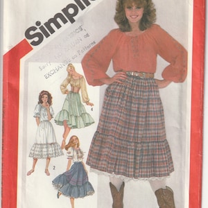 May include: Simplicity pattern 5283 for Misses' clothing. The image shows a woman wearing a plaid skirt, an orange blouse, and cowboy boots. The pattern includes transfers for embroidery. Size 16.
