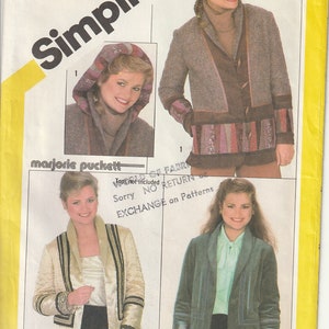 May include: Simplicity sewing pattern featuring three jacket designs. The pattern includes a hooded jacket, a gold-toned jacket with black trim, and a green jacket with geometric accents. The pattern is size 14.