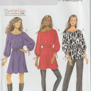 May include: Butterick B5527 sewing pattern featuring three top options. The illustrations show a purple dress, a red top, and a black and white patterned top. The pattern includes the text "The Cut Line" and size information.