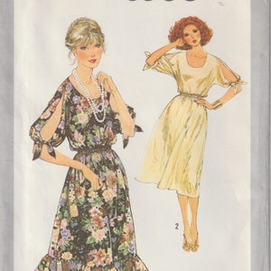 May include: Simplicity pattern 8586 featuring two dress designs. One dress is a floral print with open sleeves and a ruffled hem. The other is a solid yellow dress with open sleeves and a gathered waist. Size 14.