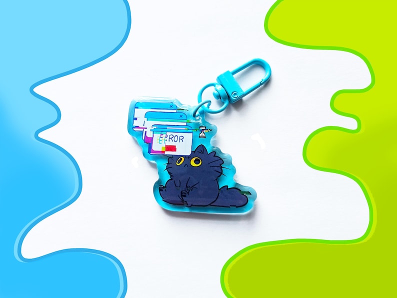 May include: A blue acrylic keychain featuring a cartoon cat with yellow eyes and a computer error message. The keychain has a blue clasp and a design of computer windows with the word "ERROR". The cat is dark blue.