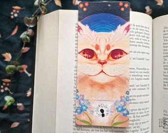 May include: A bookmark featuring a white cat with red eyes and a blue background. The cat is surrounded by forget-me-not flowers. The bookmark has a small silhouette of a person in the center.