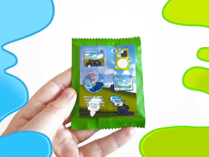 May include: A green packet featuring cartoon illustrations of a black cat in various scenes. The packet includes text and images of a cat in a fishbowl, a computer screen, and other playful designs. The words "SECRET RARE" are also visible.