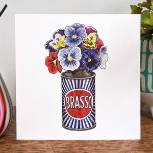 May include: A watercolour illustration of a bunch of purple, red and yellow pansies growing out of a vintage can labelled "BRASSO".