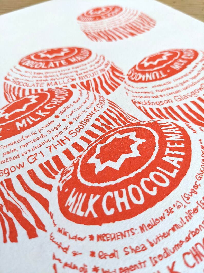 May include: Close-up of a red and white printed label with the text "MILK CHOCOLATE" and "INGREDIENTS: Mallow 38% (Sugar, Glucose Syrup, Shea Butter, Emulsifier (Soya Lecithin), Sodium Carbonate)."