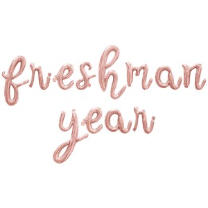 May include: Rose gold foil balloons spelling out "freshman year" in a cursive font.