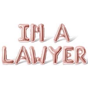 May include: Rose gold foil balloons spelling out "I'm a Lawyer".