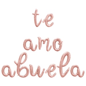 May include: Rose gold foil balloons spelling out "te amo abuela" in cursive script.
