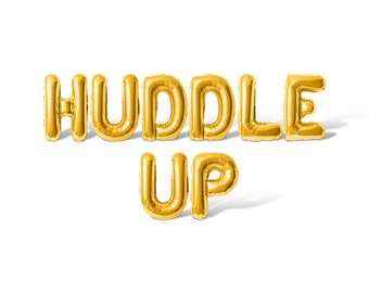 May include: Gold foil balloons spelling out "HUDDLE UP" against a white background.